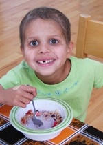 sofia eating cereal, hair starting to grow back